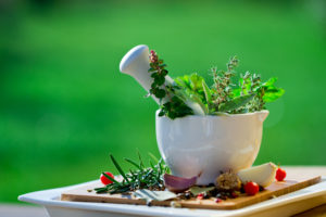 Fresh herbs in the mortar - alternative medicine
